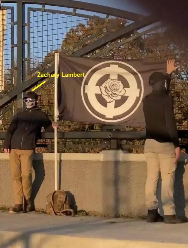 Neo-Nazi Zachary Lambert, posing with a celtic cross flag on an overpass in Newberg Oregon