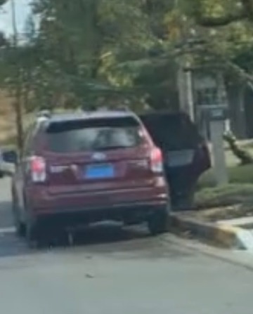 A maroon Subaru Forester belonging to Neo-Nazi Zachary Lambert, with the license plate covered in tape, at the transphobic anti-LGBTQ rally in Eugene.
